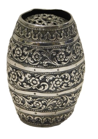 A Continental pepperette, of barrel form, with embossed floral scroll decoration, white metal stamped OM, 6cm high, 1.77oz.