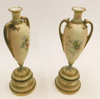 A pair of Royal Worcester blush ivory ground two handled vases, painted with flowers, on a tapering stem and domed foot, printed marks in puce to underside, registration number 304838 above 1957, 27cm high. - 3