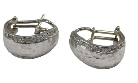 A pair of half hoop earrings, set to the sides with tiny diamonds, in white metal, pins indistinctly marked, 10.7g.