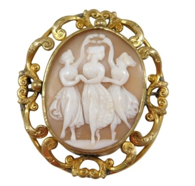 A late 19thC shell cameo brooch, carved with the Three Graces, in a yellow metal mount, with a surround of engraved C scrolls.