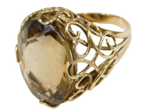 A gold and citrine ring, the oval cut citrine in an openwork setting, yellow metal, bears indistinct Continental marks, size Q, 10.5g.