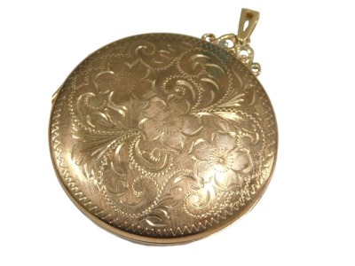 A 9ct gold photo locket pendant, of circular form, with engraved floral and foliate decoration, 24.8g all in.