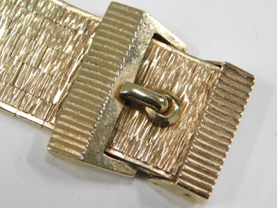 A 9ct gold textured bracelet, on a belt and buckle clasp, 52.6g. - 3