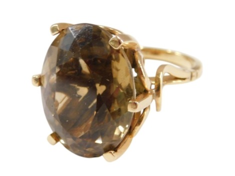 A smoky quartz ring, the oval cut quartz in a basket setting, yellow metal, unstamped, size O½, 17.2g.