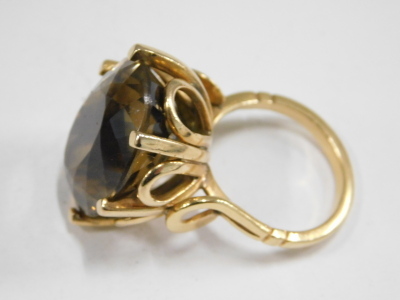 A smoky quartz ring, the oval cut quartz in a basket setting, yellow metal, unstamped, size O½, 17.2g. - 2