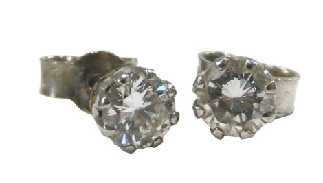 A pair of diamond single stud earrings, in white metal, each approx 0.35ct, 1.4g.