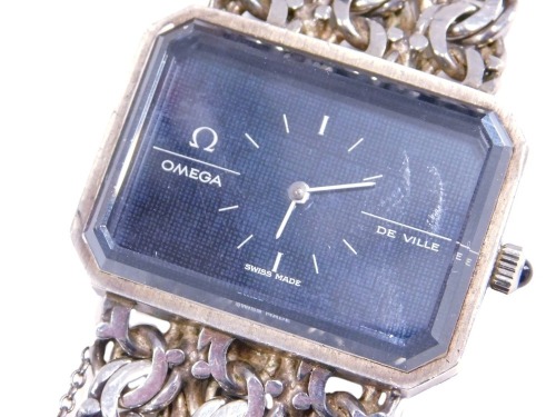 An Omega DeVille lady's silver cased wristwatch, canted black rectangular dial, on a three bar circular link bracelet strap.