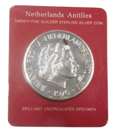 A Netherlands Antilles twenty five guilder sterling silver coin, in original packaging.