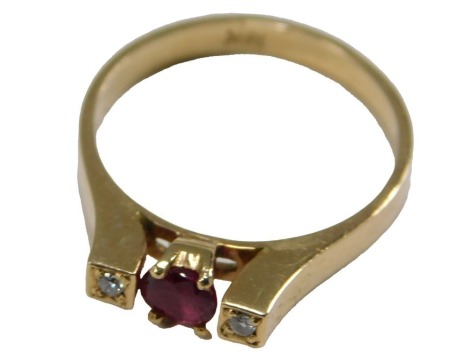 A 20thC ruby and diamond three stone dress ring, set with oval cut ruby, approx 4.5mm x 4mm x 3mm, 0.45ct, claw set, flanked by two illusion set round brilliant cut diamonds, each approx 0.02ct, on a yellow metal band, unmarked, believed to be 18ct, ring 