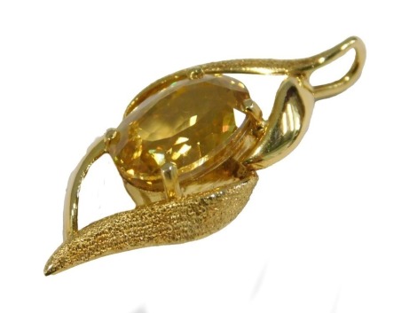 A 20thC citrine pendant, the single stone set pendant drop with oval mixed cut yellow citrine, 12mm x 8mm, approx 2.67ct, in a yellow metal frame, unmarked, believed to be 18ct, some of brushed design, 4.6g all in, 3cm high.