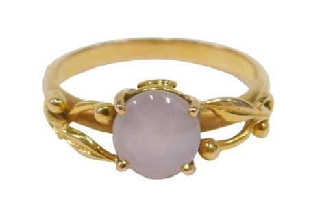 A 20thC star sapphire dress ring, set with cabochon cut white, grey, opaque star sapphire, 7.73mm x 7.30mm x 5.16mm, approx 3.14ct, in a yellow metal setting with scroll design shoulders, believed to be 18ct, sing size P, 3.90g all in.