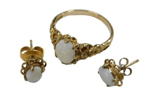 A 9ct gold and opal ring, size M½, together with a pair of matching single stud earrings, 3.5g.