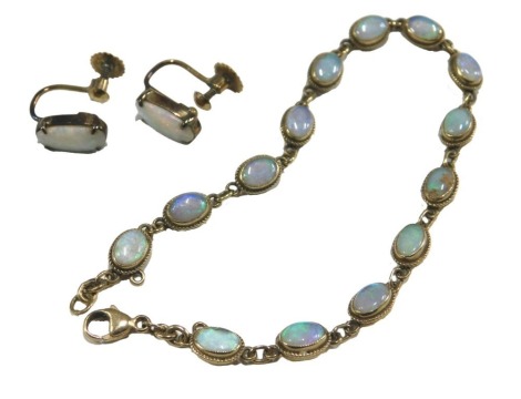 An opal bracelet, with chain links, on a lobster claw clasp, stamped 9ct, together with a pair of opal earrings, with screw fittings, stamped 9ct, 6.8g.