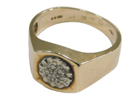 A 9ct gold and diamond flower head ring, in a recessed oblong setting, size R, 4.8g.