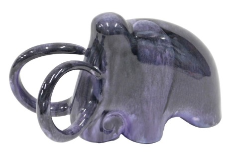 A Russian studio type ware Konakova model of a mammoth, with purple glaze, 27cm wide.