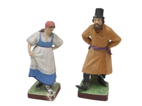 A near pair of 19thC Russian Gardner bisque porcelain figures, she wearing a blue dress with a spotted pinafore, and a pink head scarf on a square base, he wearing a black hat and boots, and a brown coat with purple belt, on square base, printed marks and