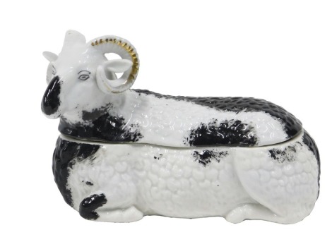 A 19thC Kuznetsov Russian porcelain box and cover, modelled as a black and white ram, printed marks in blue to underside, 18cm long.