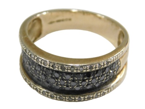 A 9ct gold black and white diamond set band, size Q, 5.6g.