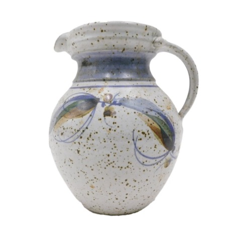 A studio pottery jug, decorated with leaves, etc., on a mottled duck egg blue ground, impressed monogram to underside, 24cm high.