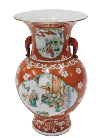 A Chinese porcelain two handled vase, decorated in famille verte palette, with figures, etc., on an iron red ground, unmarked, 30cm high. (AF)