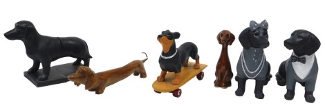 A collection of novelty Dachshund figures, to include a pair of figures dressed in gentleman's and lady's evening dress, figure on a skateboard, bookends, etc. (6)