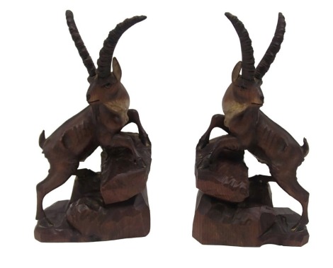 A pair of late carved pine Black Forest bookends, each in the form of a mountain goat or chamois, 30cm high.