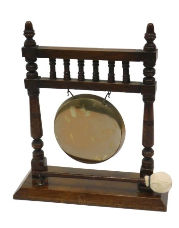 A late 19th/early 20thC oak framed dinner gong, with bronze gong, etc., 33cm wide.