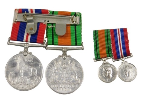 Two George V medals, comprising The Defence Medal and The 1939-45 Medal, together with miniatures.