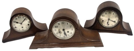 Three 20thC oak mantel clocks, each with silvered numeric dials, and twenty-one day movement.