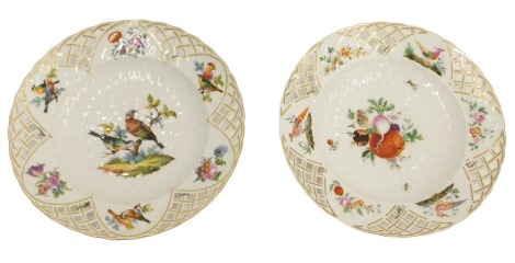 A pair of KPM Berlin porcelain plates, with pierced borders, one decorated with fruit, the other with two birds, 24cm diameter.