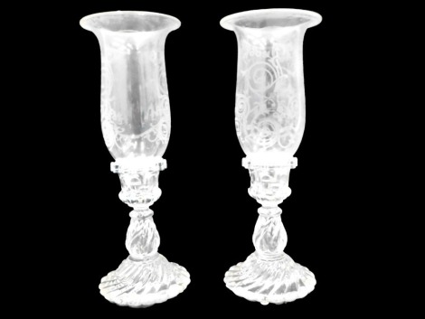 A pair of glass storm lanterns, each with an engraved shade, 36cm high.