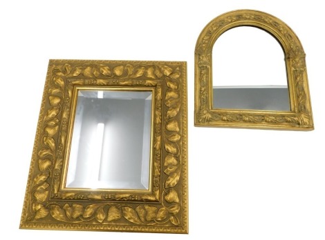 A gilt wall mirror, the framed decorated and moulded with leaves, etc., 40cm x 35cm, and an arched wall mirror, 32cm high.