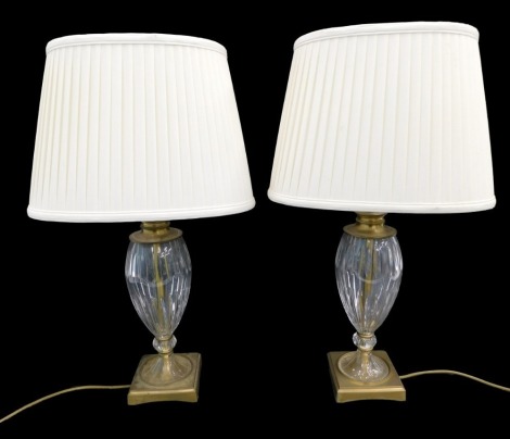 A pair of cut glass and brass mounted table lamps and shades, 48cm high to top of bulbs.