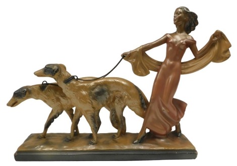 An Art Deco chalkware figure group, modelled in the form of a lady with two Borzoi hounds, 49cm wide. (AF)