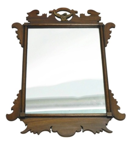 A George III style fret framed wall mirror, the pierced crest decorated with a bird, 66cm x 43cm.