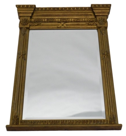 A Victorian style gilt gesso over mantel mirror, with a moulded frieze above a rectangular bevelled plate, flanked by moulded pilasters, 80cm high, 56cm wide.