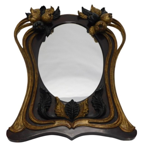 An elaborate gilt gesso and green painted wall mirror, in art nouveau style, with an oval plate, the frame embellished with fruit, leaves, etc., 130cm high, 100cm wide.