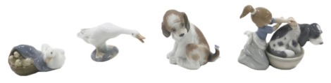 A collection of Lladro figures, to include girl washing dog, goose with goslings, dog and a goose, some boxes.