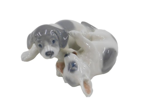 A Royal Copenhagen porcelain figure group of two playful puppies, impressed marks and numbered 453 to underside, 9cm long.