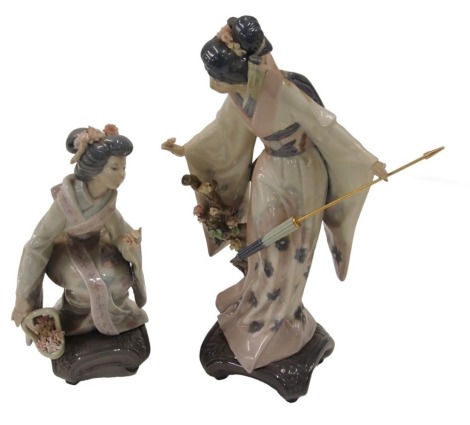 A Lladro porcelain figure of an oriental lady holding a parasol, 26cm high, and another similar. (2, AF)