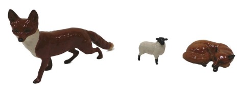 Two Beswick figures, a running fox and a lamb, and a similar fox. (3)