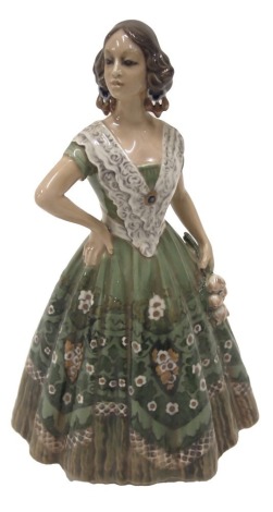 A Dahl Jensen of Copenhagen porcelain figure of a Flamenco dancer, wearing an elaborate floral dress, printed marks in green to underside and numbered 1124, 26cm high.