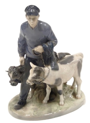 A Royal Copenhagen porcelain figure group, modelled in the form of farmer and two calves, printed marks in green to underside and numbered 1858, 18cm long.