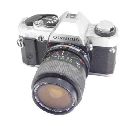 An Olympus OM20 camera, with lens.