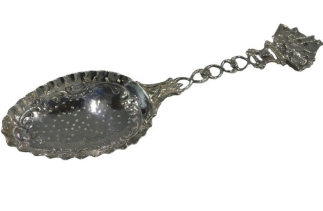 A Continental white metal sifter spoon, the pierced handle cast with a sailing boat, indistinct import marks, possibly London, 2.4oz.