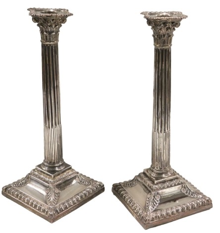 A pair of Victorian silver Corinthian column candlesticks, London 1871, each on a square loaded base, 31cm high.