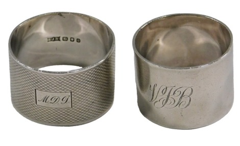 A plain cylindrical silver napkin ring, engraved initials VJB, and an engine turned napkin ring also bearing initials, 3.2oz.