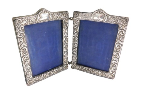 An Edward VII silver mounted double photograph frame, with acanthus scroll embossed decoration, Chester 1904, 18cm high.