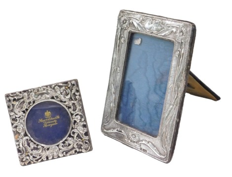 A Chester hallmarked silver mounted photograph frame, with embossed Art Nouveau style decoration, 18.5cm high, and another silver mounted frame, 10cm high. (2)