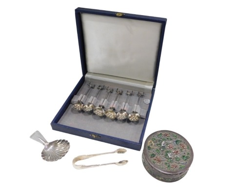 A George VI silver caddy spoon, Birmingham 1951, silver hallmarked sugar tongs, a cased set of six coffee spoons, marked Mesker 835, with an enamel decorated trinket box.